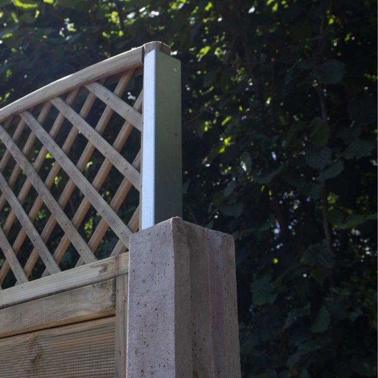 A pair of Fencemate trellis extension brackets being used to secure a wooden lattice trellis to a concrete fence post. The galvanised steel brackets slide into the post's channel, allowing for easy height extension of an existing fence.