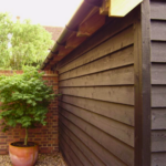 Black featheredge barn cladding installed on outbuilding exterior - Timberstore