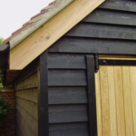 Pre-painted black featheredge cladding on garden building - Essex barn cladding - Timberstore
